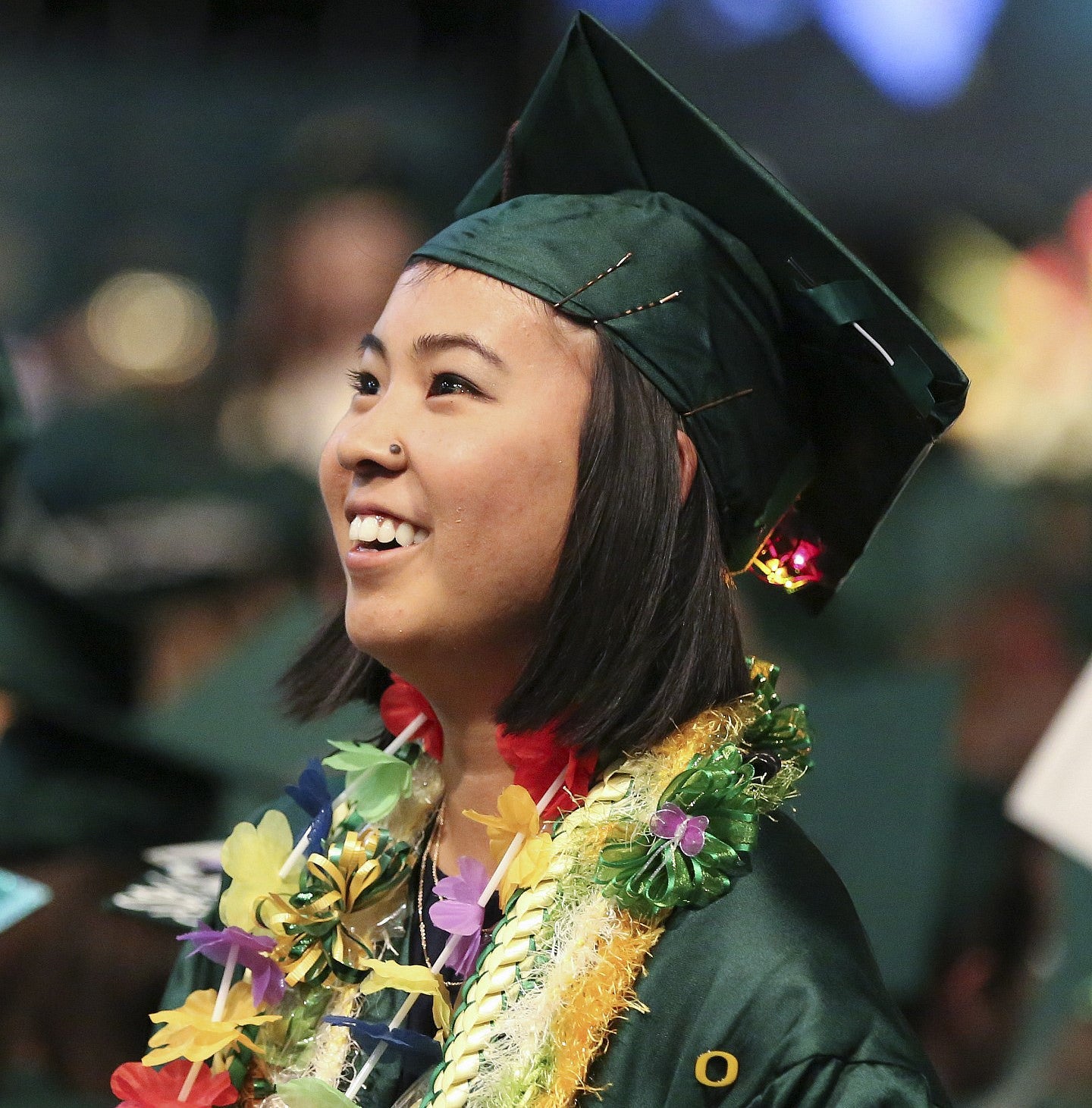 student smiles at graduation