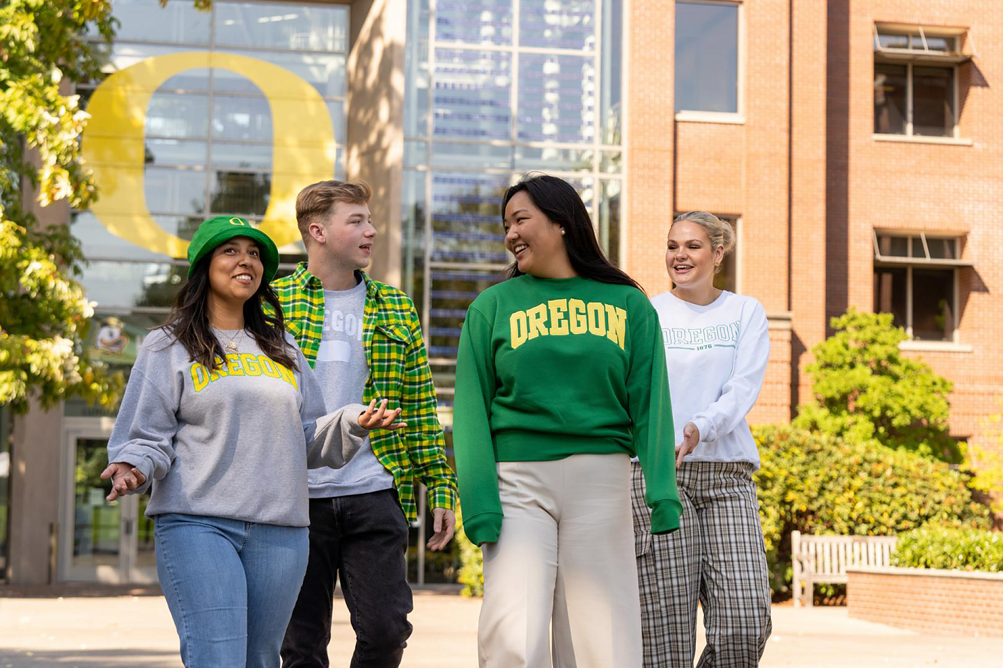 university of oregon students walking together in branded oregon apparel that is green and yellow