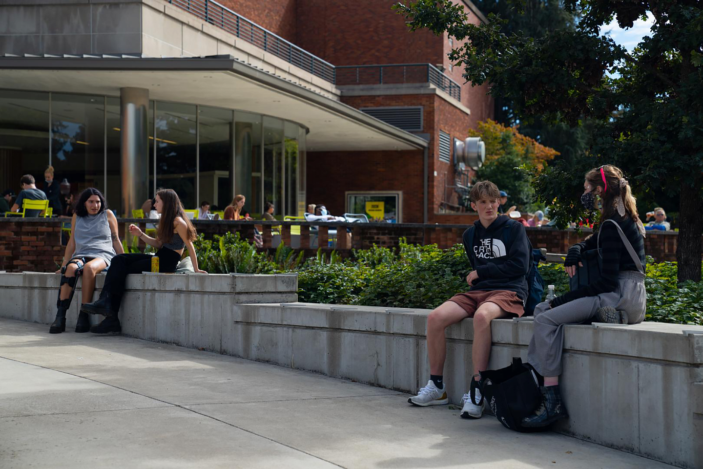 students sitting outside and talking at the erb memorial union amphitheater