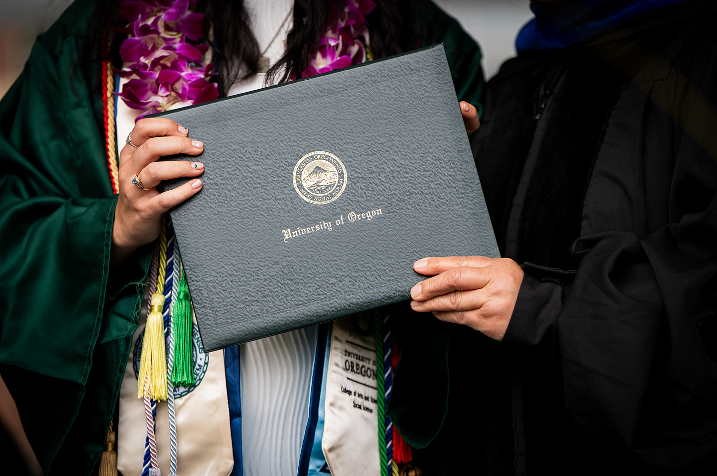 commencement student holding diploma 