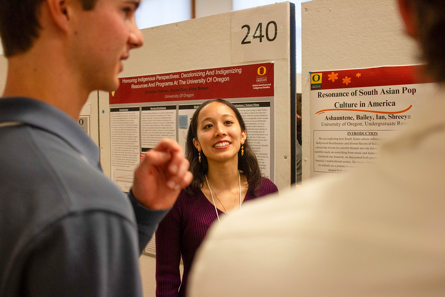 Undergraduate Research Symposium student presenting and interacting with attendees