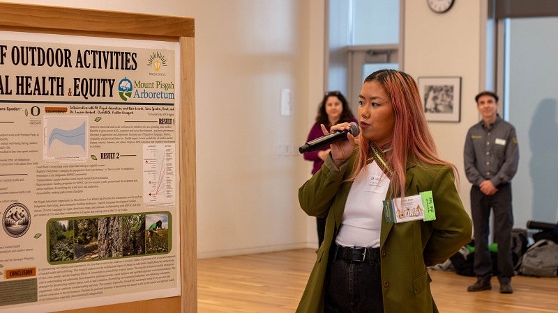 DucksRISE student Dim Dim, class of 2025, presenting her research on outdoor therapy at the Scholars Recognition Day Research Event