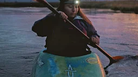 person on kayak at night