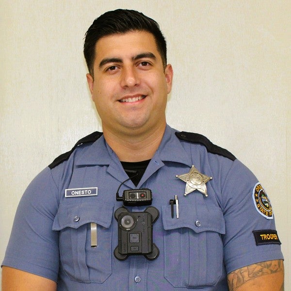 PathwayOregon alumni Arturo Onesto Oregon State Trooper headshot. He is wearing a blue police uniform.